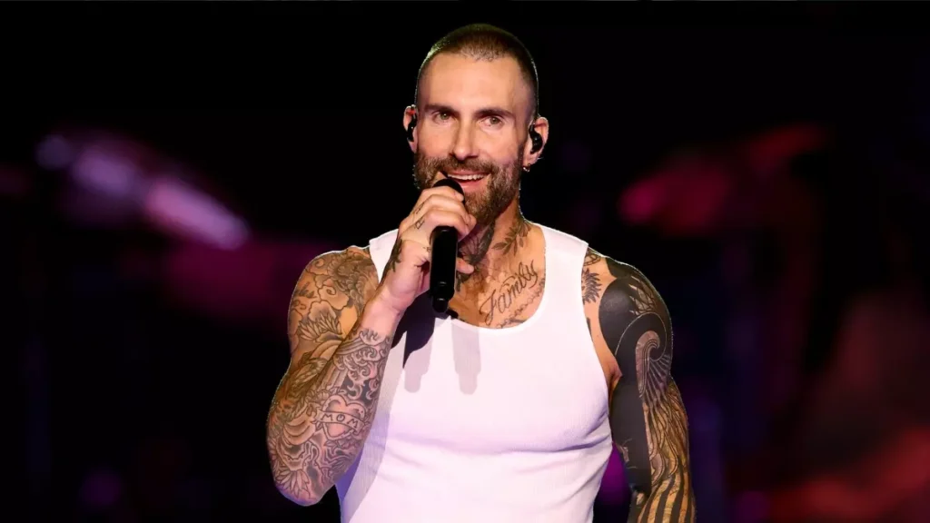Adam Levine, lead singer of Maroon 5, performing on stage.