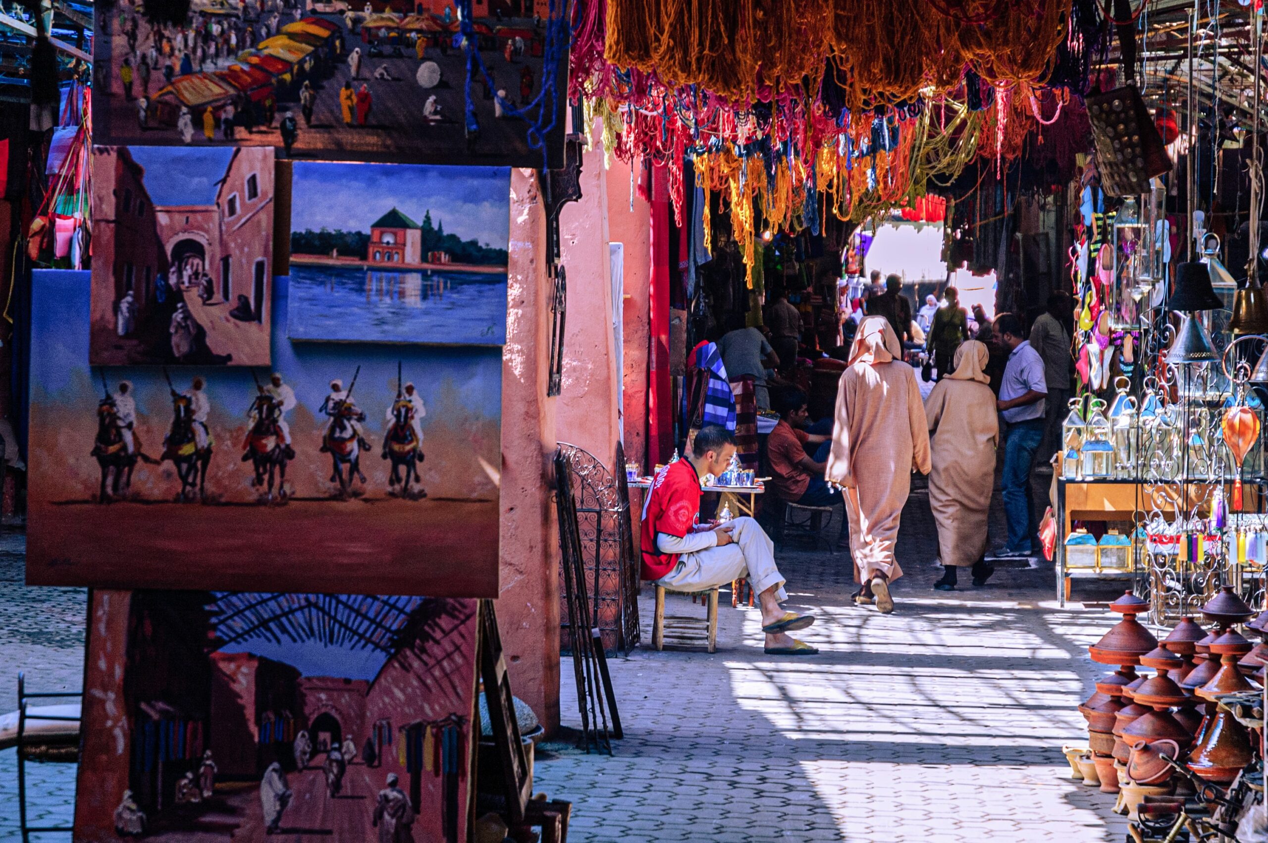 Busy Jemaa el-Fnaa square at night with illuminated food stalls, steam, and crowds in Marrakech, Morocco.
